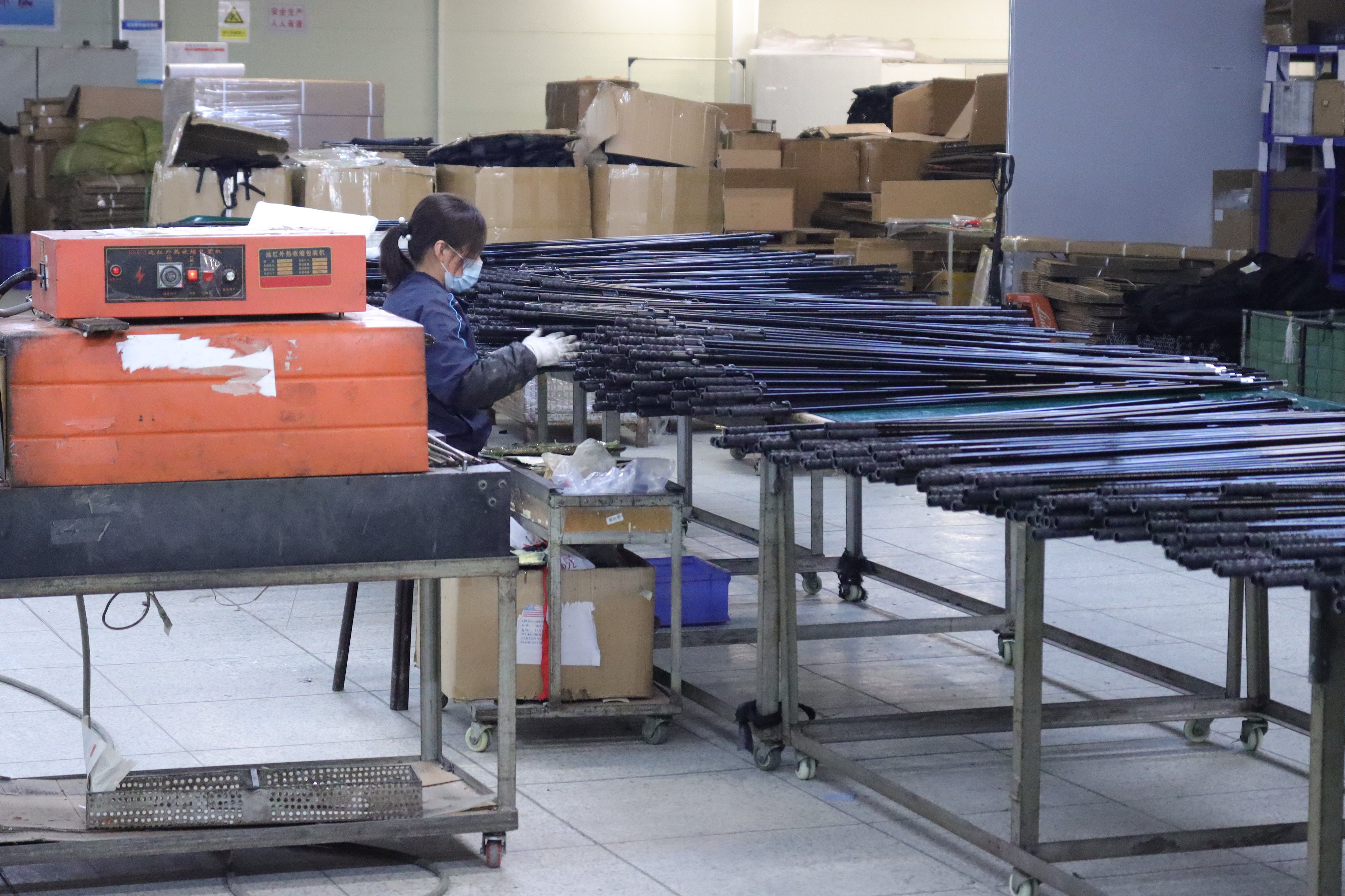 The production process of flagpoles in the factory building